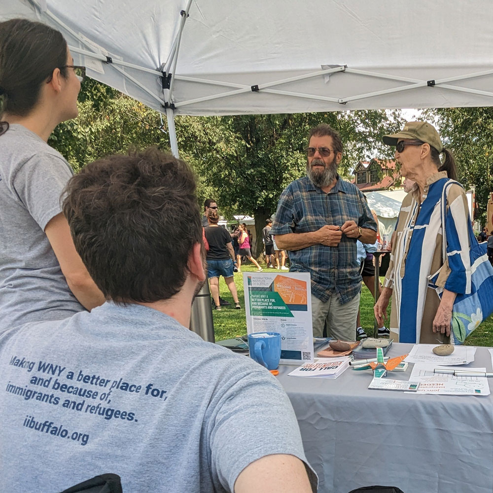 IIB volunteers speak to interested people at an event